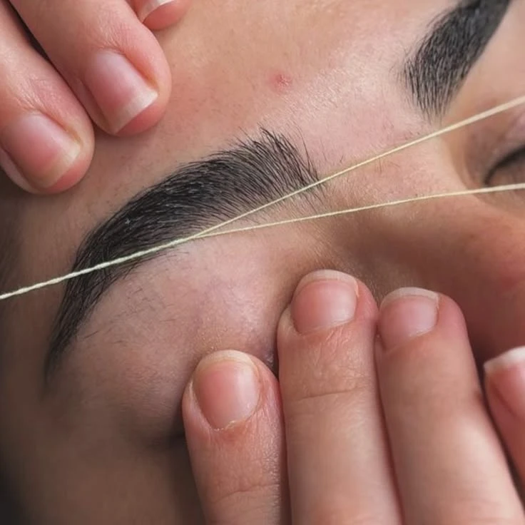 Professional eyebrow threading and shaping process during pre-wedding beauty prep