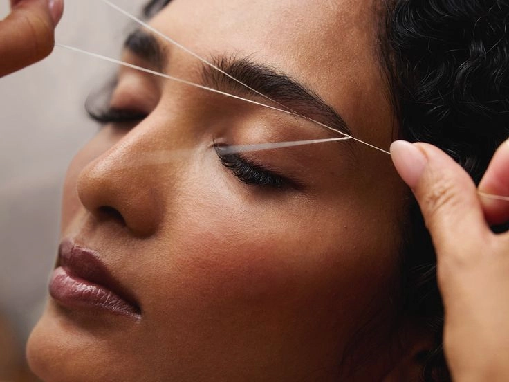 Detailed eyebrow threading technique performed at Meena Beauty Salon in Woodside Queens