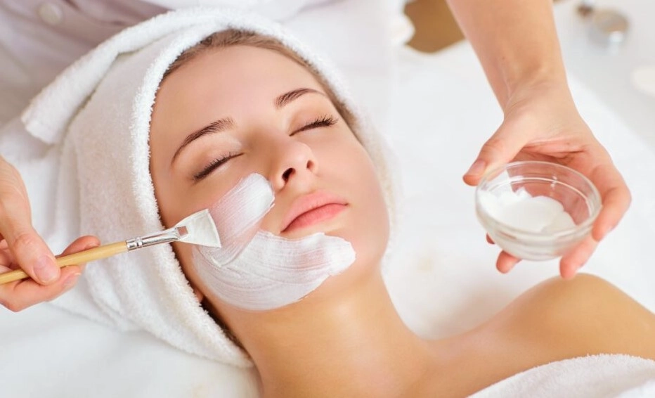 Client receiving professional facial mask brush application at Meena Beauty Salon